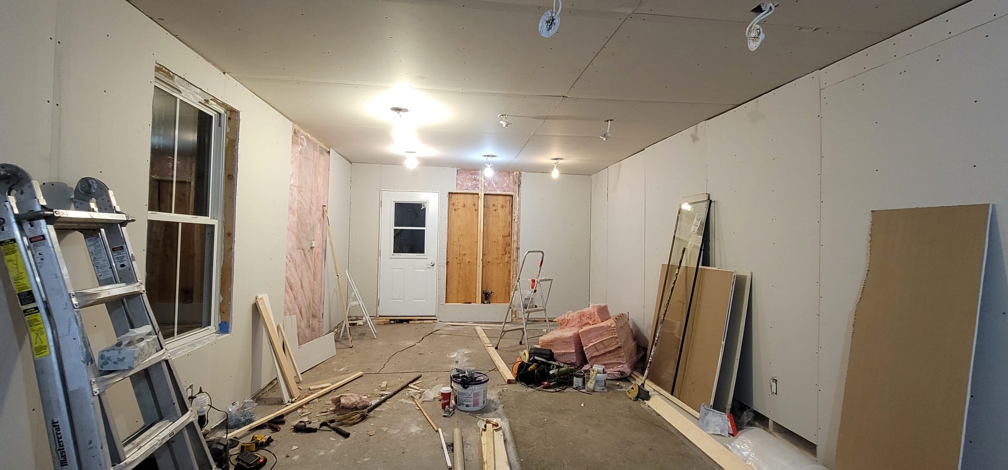 Drywalled shell to finished retail studio — before, Kitchener